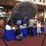 Here's an alt tag for the image: Giant meteorite display at museum.