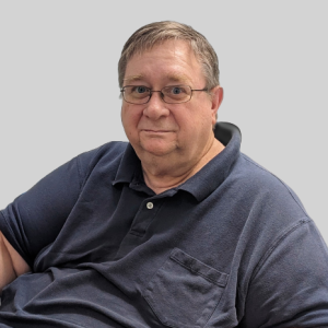 Man in glasses, dark polo shirt.