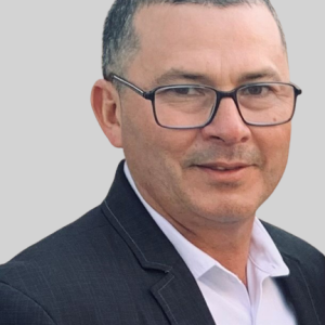 Man in suit and glasses, headshot.
